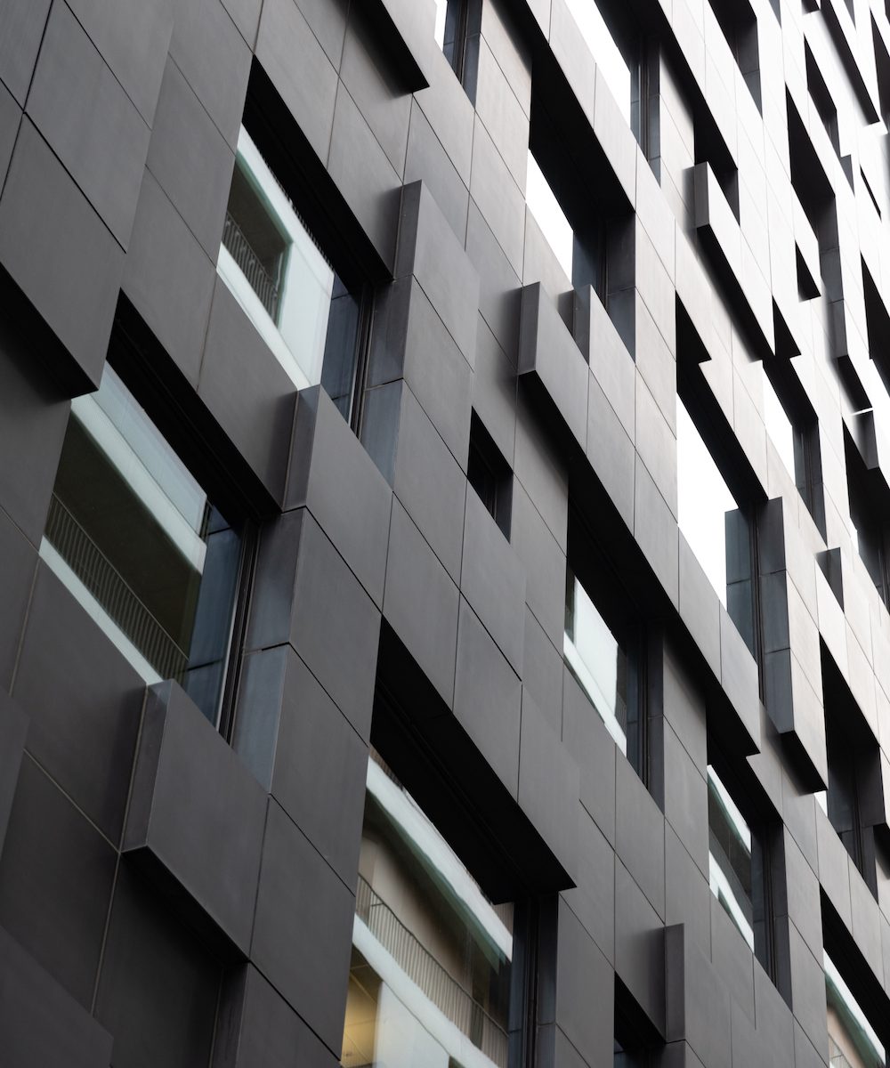 Futuristic and Contemporary Building in Modern City. Blocks and windows. Urban background.