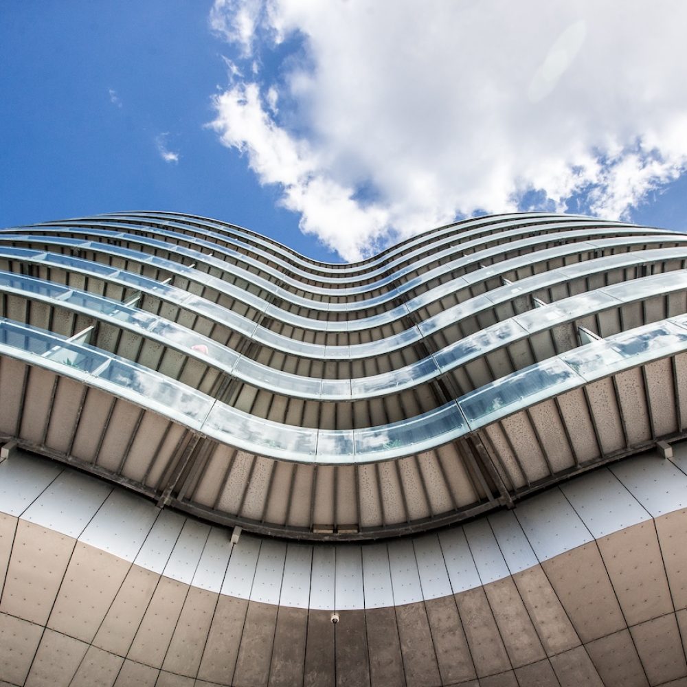 A low angle shot of the Gemini Residence buildings with a blue sky in the background