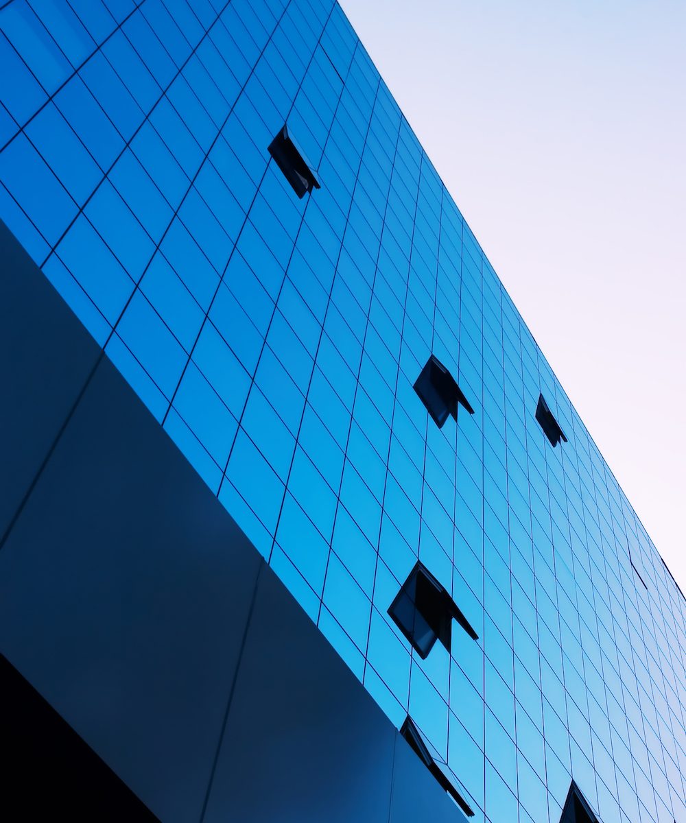 business building with some opened windows on mirror fasade